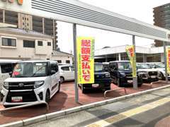 大通り沿いのダイハツの看板が目印です。新車・中古車併売の店舗ならではのご検討も当店にお任せください。