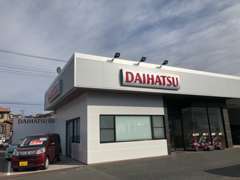 ご来店の際はこちらの建物へお越しください。ダイハツの看板ですがトヨタの中古車センターです。
