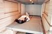 日産の「“車中泊専用”バン」がスゴすぎた！ めちゃ快適「木目オシャレ空間」に180cm超え「巨大ベッド」装備！ 新たな「マイルーム」シリーズで実際に「寝てみた」印象は？